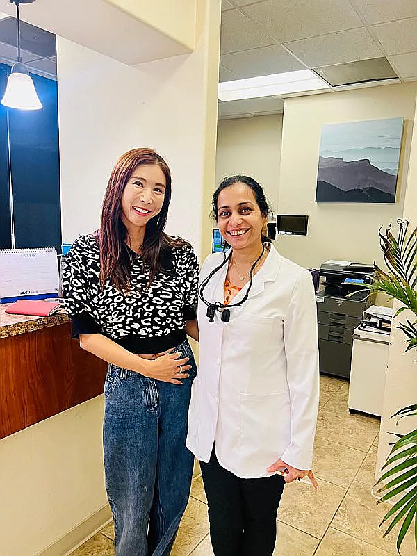 Dr. Kanak Trivedi with a patient beside the front desk