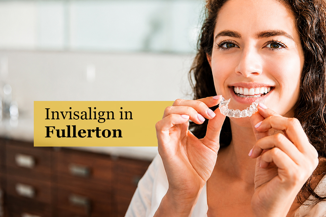 Smiling woman holding a clear aligner tray, under the title Invisalign in Fullerton