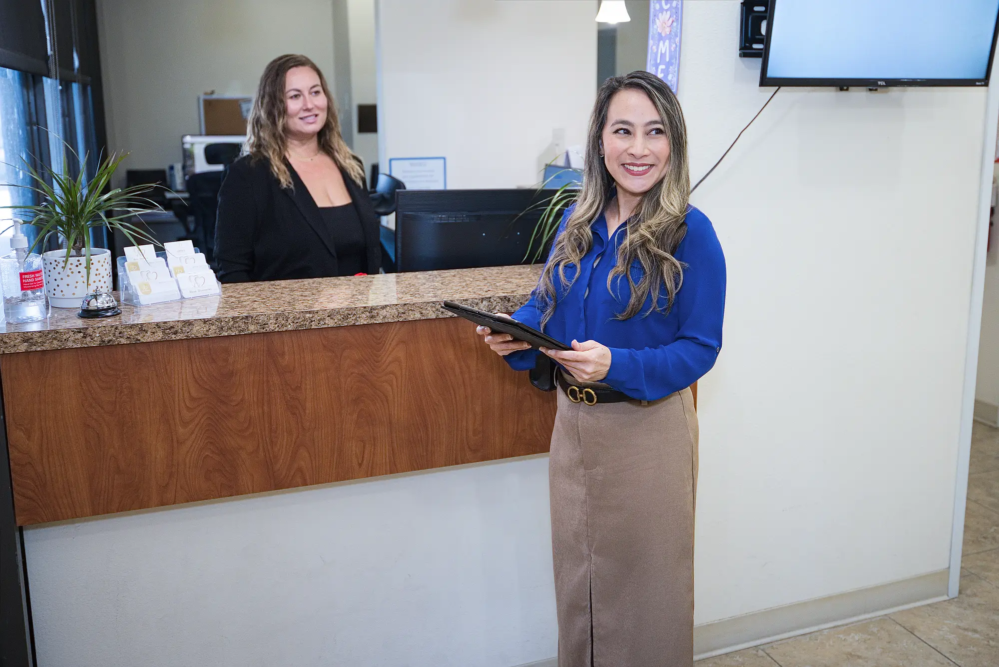 Patient holding a tablet at the reception desk