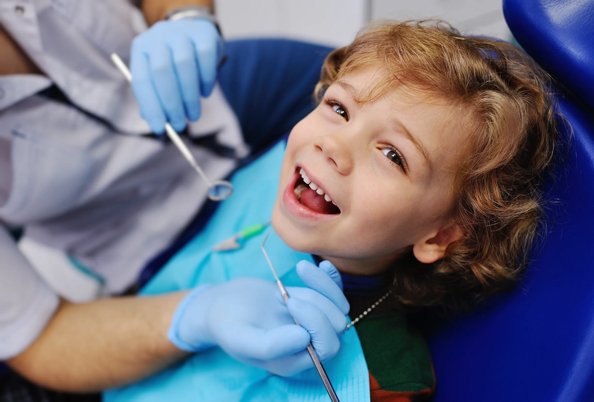 Young boy smiling in the dental chair during a children's checkup