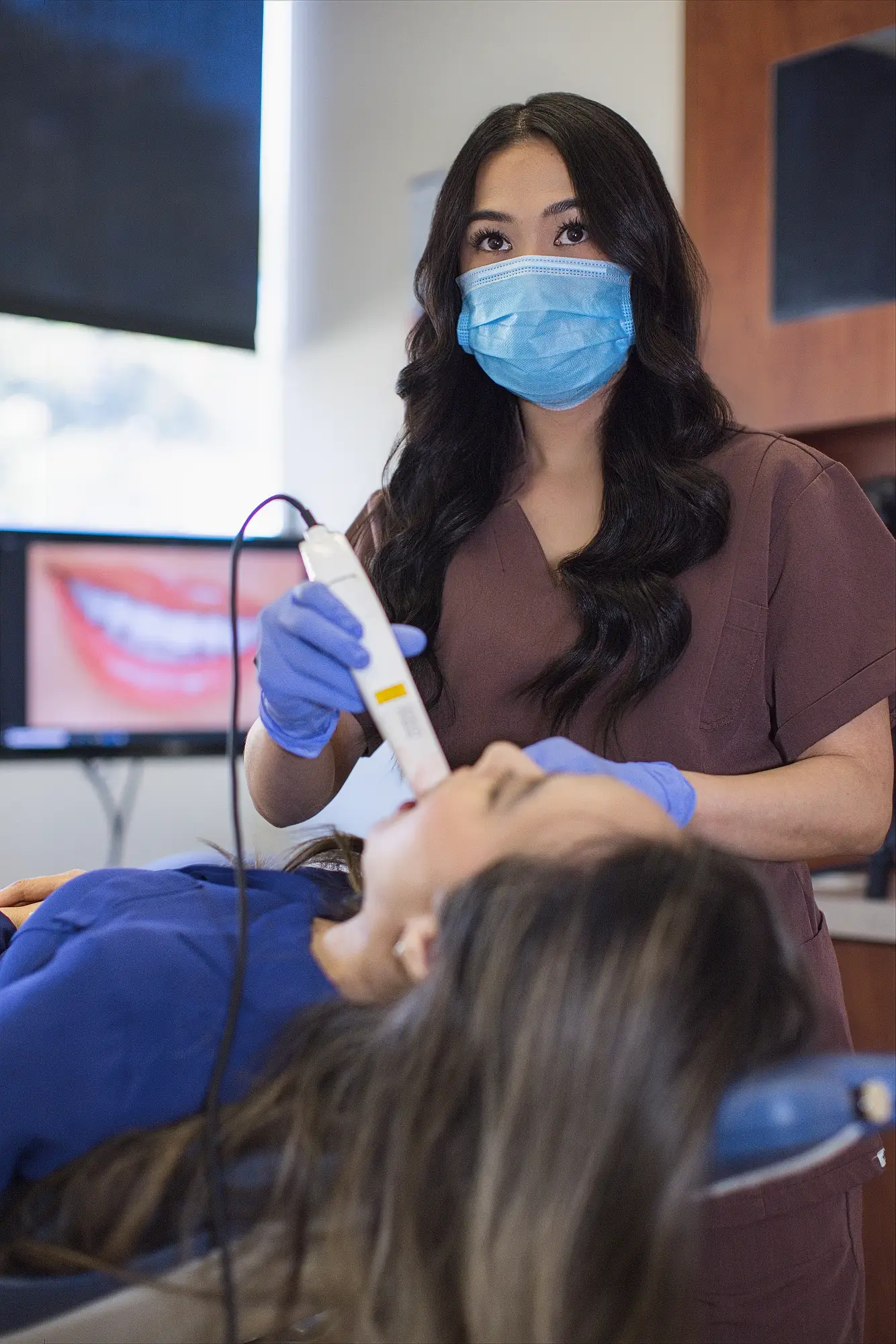 Dental assistant treating a patient at Real Dentistry